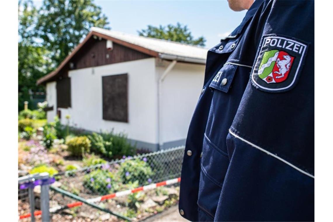 Ermittler decken schweren Kindesmissbrauch auf Ein Polizeibeamter steht vor der Gartenlaube in Münster, wo der vermutliche Haupttäter Teile seiner Server-Anlage unterbrachte. Foto: Guido Kirchner/dpa