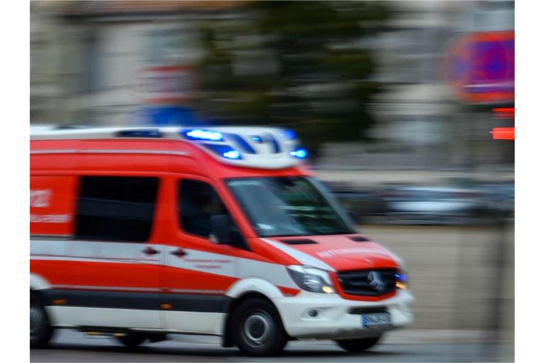 Ein Rettungsfahrzeug der Feuerwehr fährt mit Blaulicht bei einem Einsatz durch die Innenstadt. Foto: Jens Büttner/zb/dpa/Archivbild