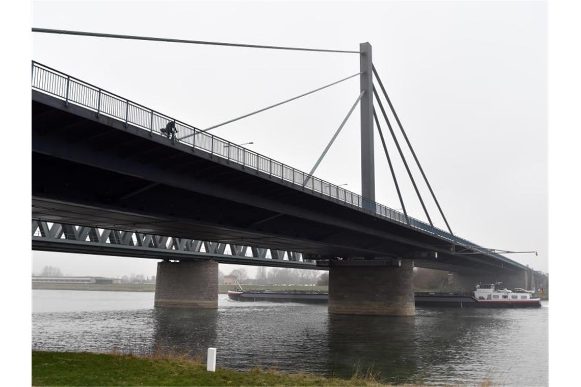 Gericht verhandelt Streit um Rheinbrücke Ein Schiff fährt under der Rheinbrücke Karlsruhe Maxau hindurch. Foto: Uli Deck/dpa