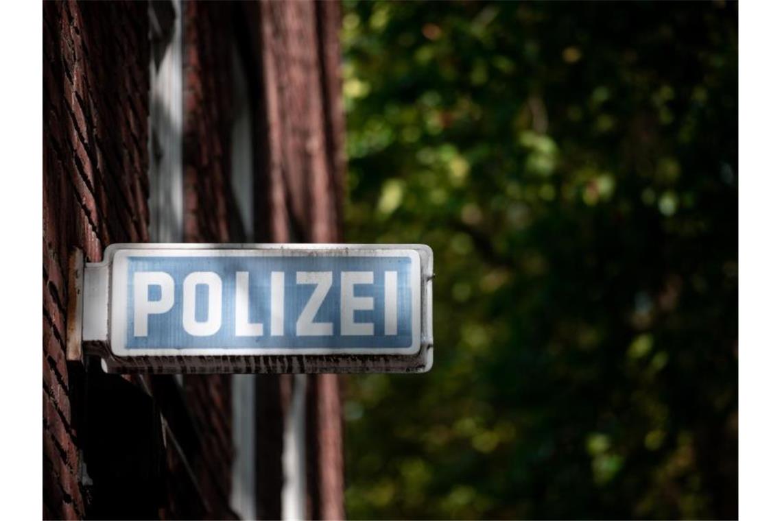 Ein Schild, auf dem „Polizei“ steht, hängt an einer Wache. Foto: Fabian Strauch/dpa/Symbolbild