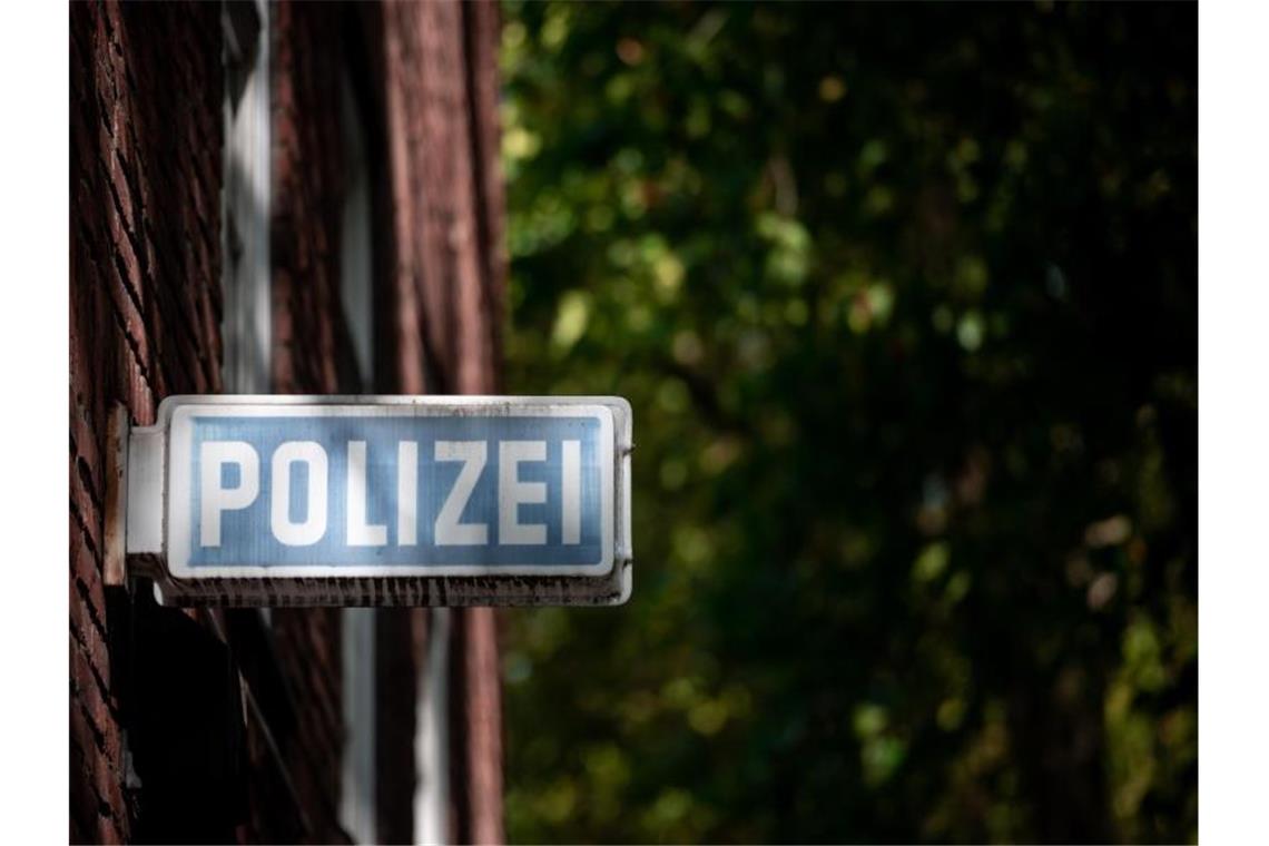 Ein Schild, auf dem „Polizei“ steht, hängt an einer Wache. Foto: Fabian Strauch/dpa/Symbolbild