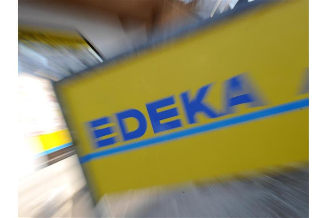 Ein Schild mit der Aufschrift „Edeka“. Foto: Tobias Hase/Archivbild