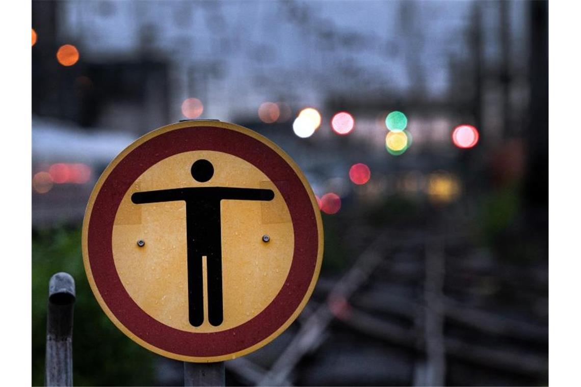 Ein Schild verbietet Passanten das Weitergehen auf die Schienen. Foto: Federico Gambarini/dpa
