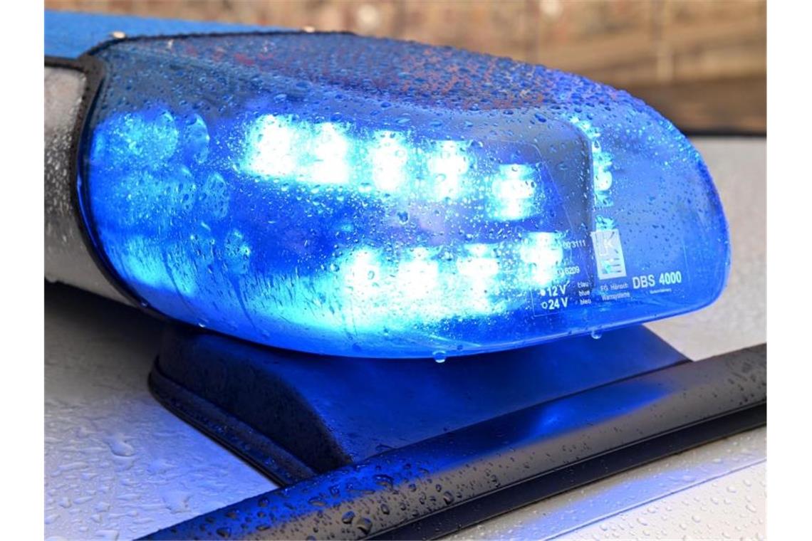 Fahrer rammt Auto und fährt beinahe Zeugin an Ein Streifenwagen der Polizei steht mit eingeschaltetem Blaulicht. Foto: Carsten Rehder/dpa
