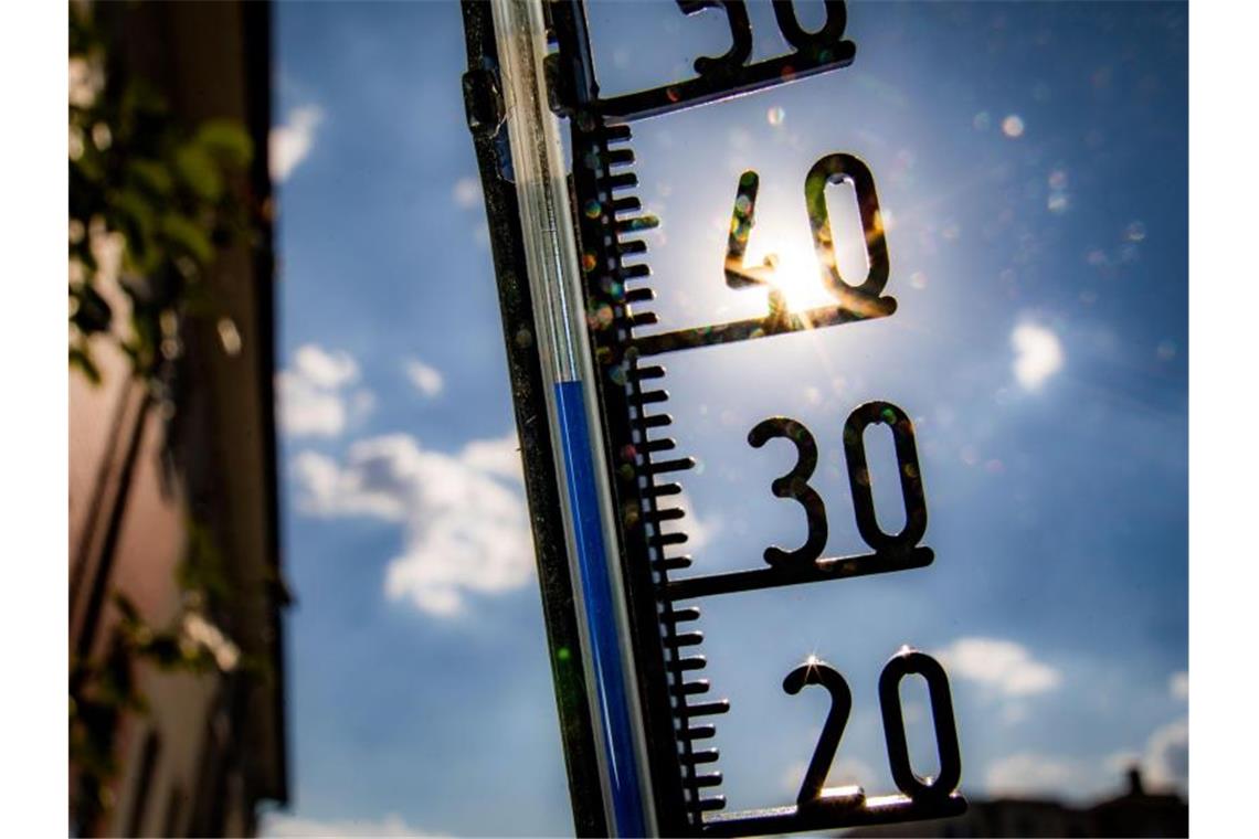 Ein Thermometer an einer Hauswand klettert am Nachmittag in Richtung der 40-Grad-Marke. Foto: Frank Rumpenhorst/Archivbild