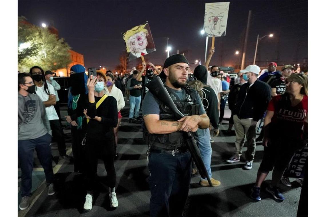 Biden fehlt nur noch ein US-Bundesstaat Ein Trump-Anhänger im Maricopa County posiert mit einer Waffe. Foto: Matt York/AP/dpa