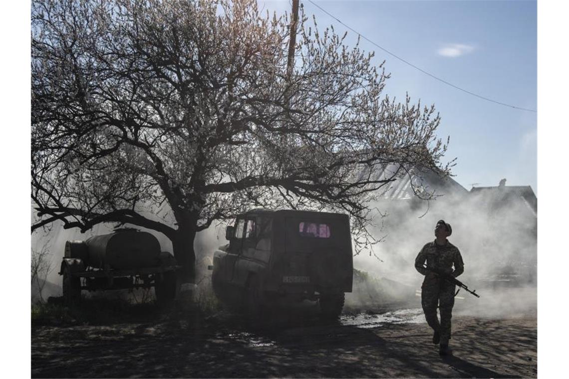 Ein ukrainischer Soldat bewacht eine Position in der Nähe der Frontlinie, während der Konflikt in der Region Donezk andauert. Foto: Evgeniy Maloletka/AP/dpa