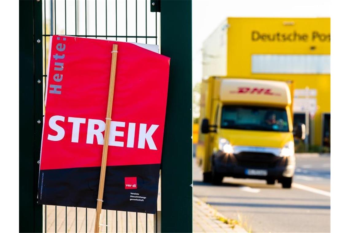 Ein Verdi-Schild mit der Aufschrift "Streik" vor einem Postzentrum. Foto: Moritz Frankenberg/dpa/Archivbild