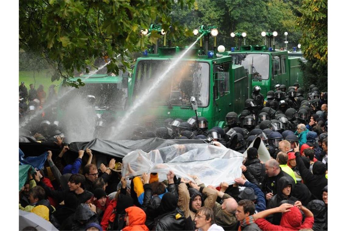 Ein Wasserwerfer spritzt in Stuttgart auf Demonstranten, die gegen die geplante Abholzung mehrerer Bäume im Park protestieren. Foto: picture alliance/dpa/Archivbild