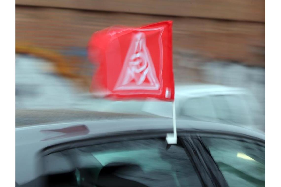 Shakshuka zum Mittag: IG Metall verlegt Warnstreiks ins Netz Eine Fahne mit dem Logo der IG Metall an einem Auto. Foto: Wolfgang Kumm/dpa/Archivbild