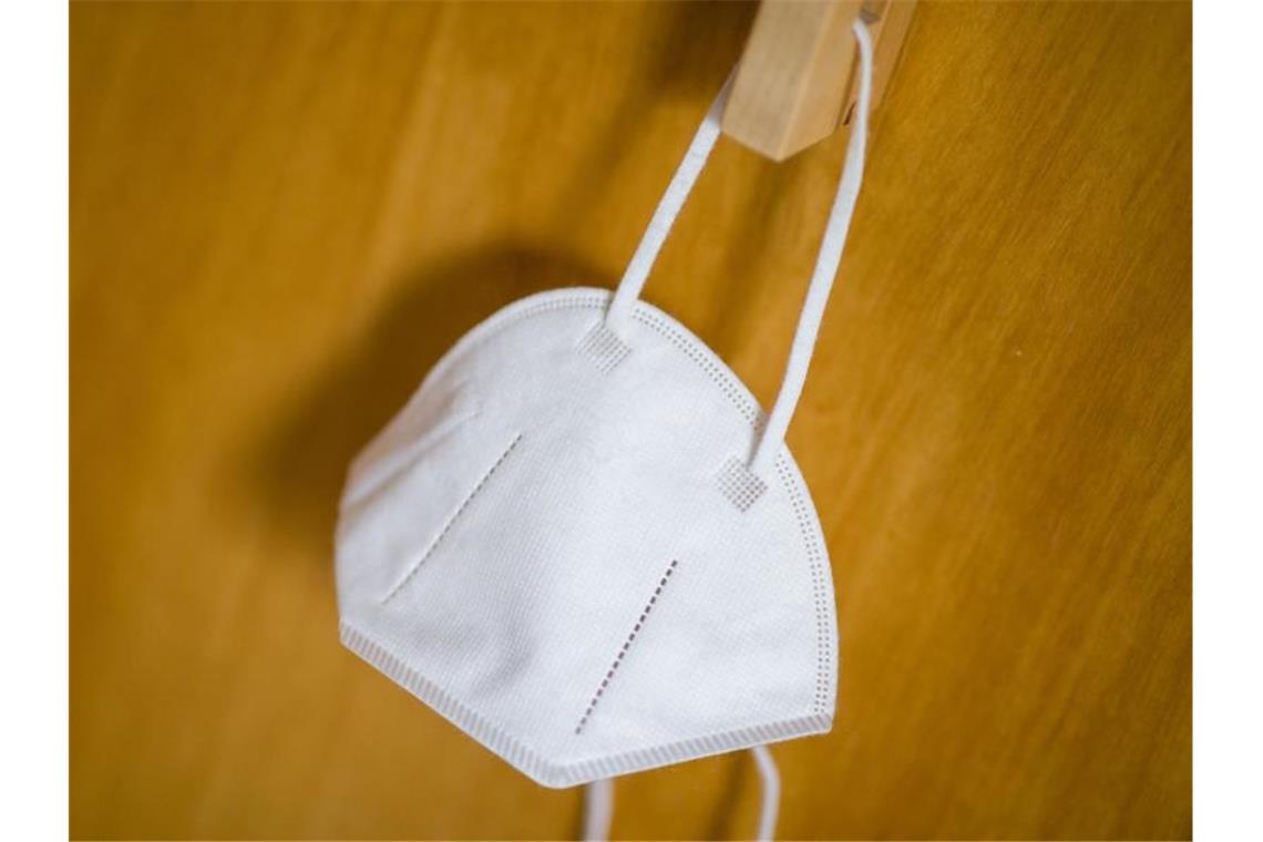 Corona: Bislang rund 12 000 Kinder im Kita-Alter infiziert Eine FFP2-Maske hängt in einer Wohnung an einem Haken. Foto: Daniel Karmann/dpa/Symbolbild