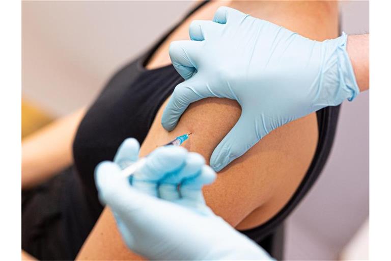 Eine Frau wird von einem Arzt gegen das Coronavirus geimpft. Foto: Moritz Frankenberg/dpa