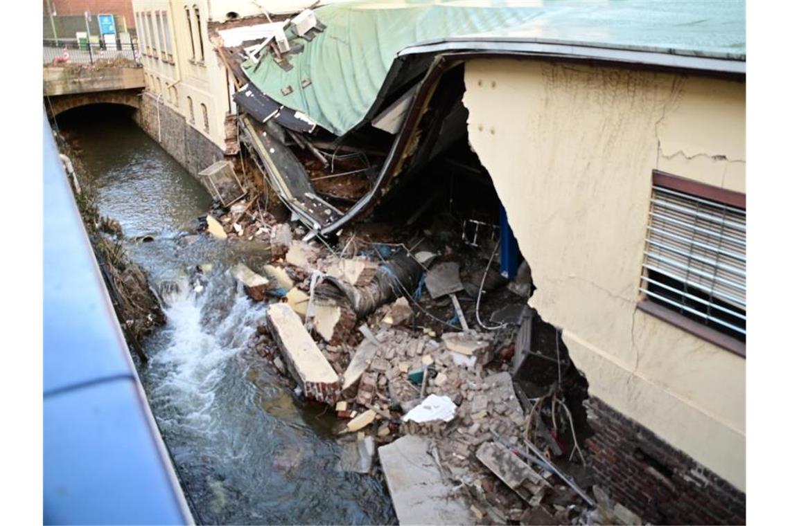 Eine ganze Hausfassade wurde durch die Fluten des Nahmerbach in Hagen herausgespült. Im weiteren Verlauf stürzte das Dach in Teilen ein. Foto: Alexander Forstreuter/dpa