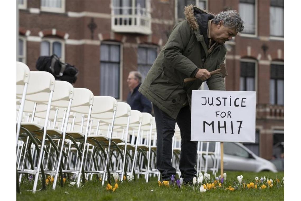 Russland auf Anklagebank: Prozess um MH17-Abschuss beginnt Eine Installation mit 298 symbolischen leeren Stühlen gegenüber der russischen Botschaft in Den Haag erinnert an die Opfer. Foto: Peter Dejong/AP/dpa