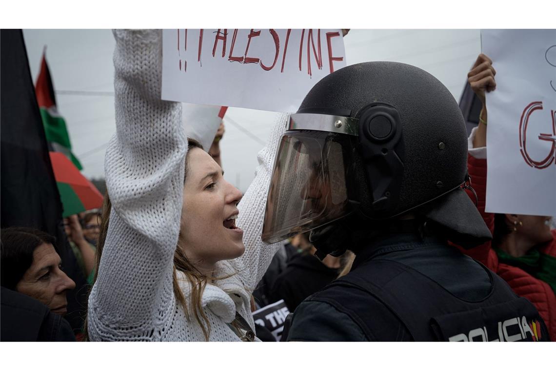Eine junge Frau protestiert vor einem Polizisten während einer Kundgebung in Spanien bei der Vuelta a España gegen den Gaza-Krieg.