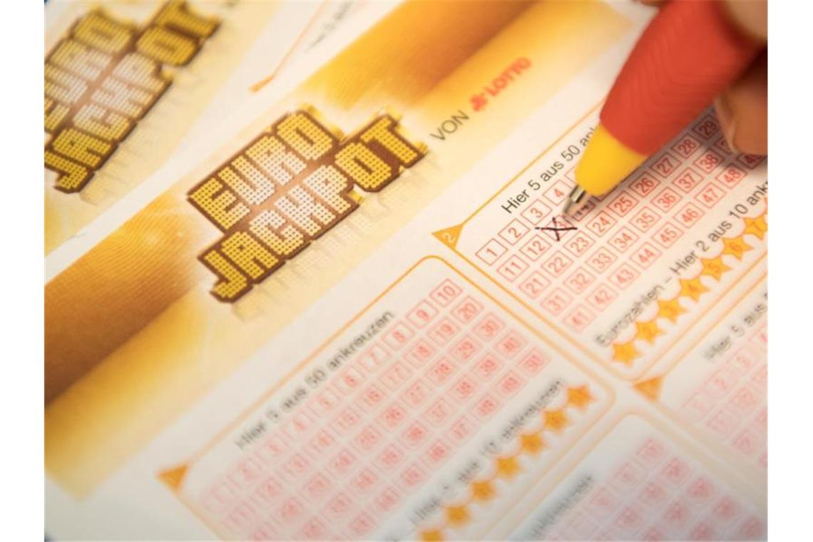 Eine Kundin füllt einen Eurojackpot-Lotterie-Schein aus. Foto: Fabian Sommer/dpa/Symbolbild