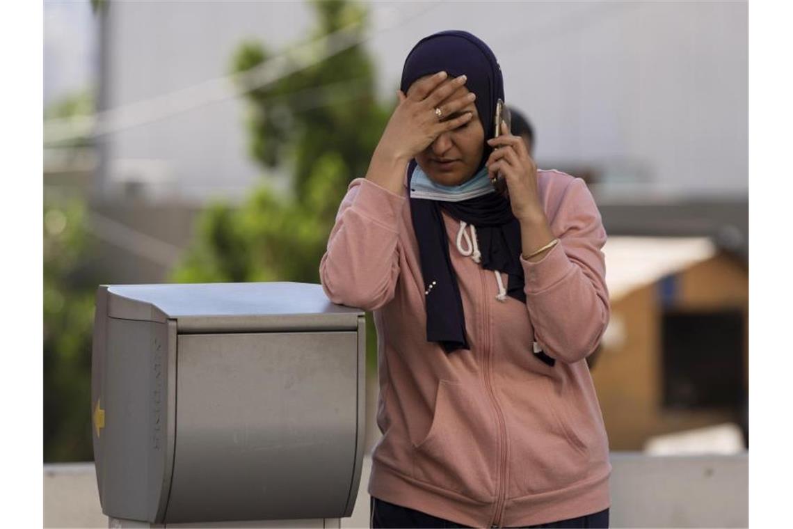 Eine Libanesin wartet vor eimem Krankenhaus auf Informationen über ihren bei der Treibstoffexplosion verletzten Bruder. Foto: Hassan Ammar/AP/dpa