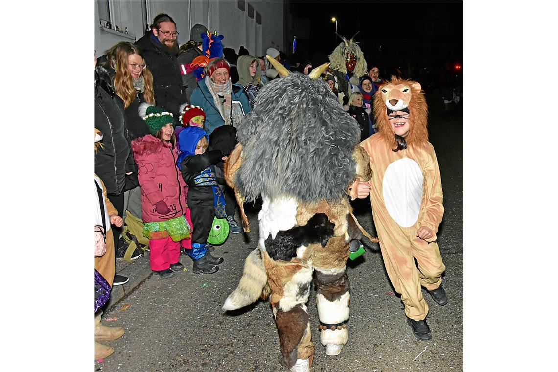 Eine Löwe tanzt mit einem Narr auf der Straße. Nachtumzug der Schbiallomba-Schlo...