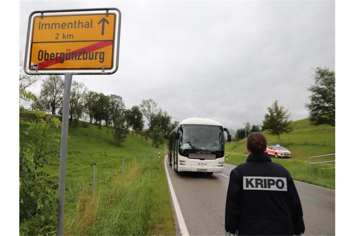 Eine Mitarbeiterin der Kripo geht auf den am Straßenrand stehenden Linienbus zu. Foto: Benjamin Liss/dpa/Archivbild