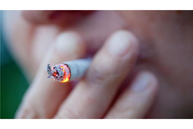 Eine Person zieht an einer Zigarette.