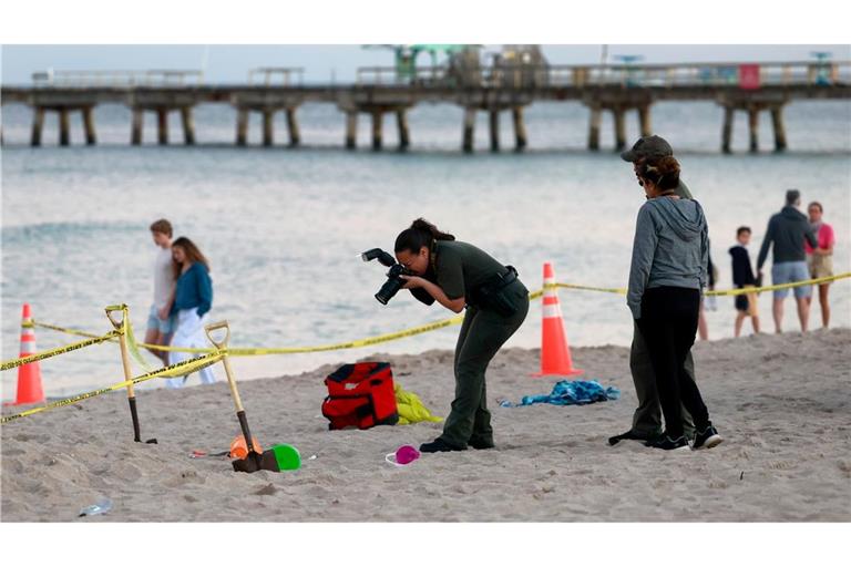 Eine Polizistin macht am Strand von Lauderdale-by-the-Sea Fotos vom Tatort.