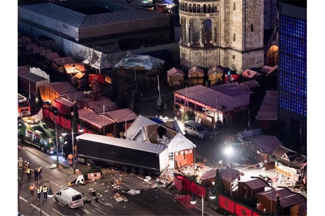 Eine Schneise der Verwüstung ist am 20. Dezember 2016 auf dem Weihnachtsmarkt am Breitscheidplatz in Berlin zu sehen, nachdem der Attentäter Anis Amri mit einem Lastwagen über den Platz gerast war. Foto: Bernd von Jutrczenka/dpa