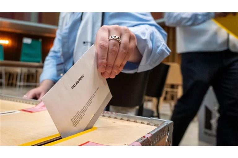 Eine Wählerin wirft in einem Wahllokal im Rathaus von Malmö ein Wahlumschlag in eine Wahlurne.