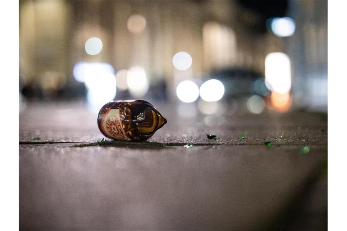 Eine zerbrochene Bierflasche liegt auf dem Boden. Foto: Christoph Schmidt/dpa/Archivbild