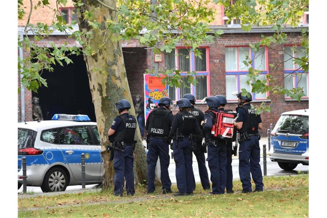 Einsatzkräfte der Polizei stehen an einem Oberstufenzentrum in Rummelsburg. Foto: Paul Zinken/dpa-Zentralbild/dpa