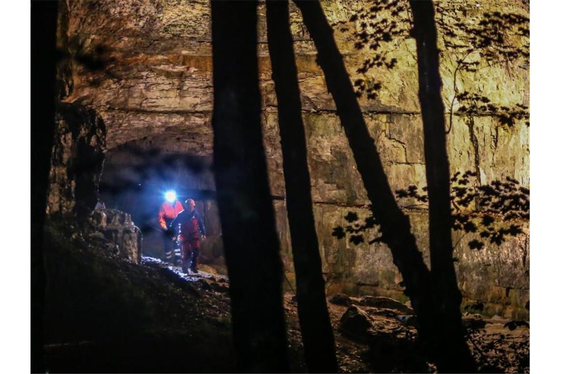 Einsatzkräfte stehen am Eingang der Falkensteiner Höhle. Foto: Christoph Schmidt/Archivbild