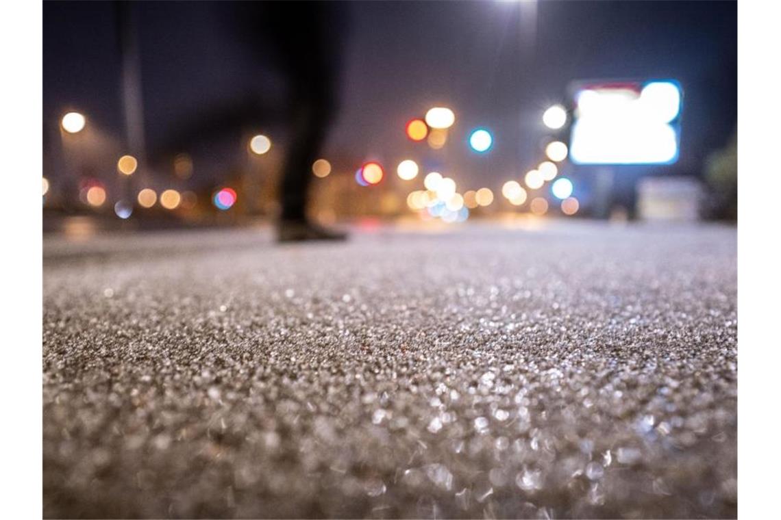Eis und Graupel bedecken den Gehweh an einer Straßenkreuzung im Frankfurter Stadtteil Bornheim, nachdem bei Temperaturen rund um den Gefrierpunkt Regen einsetzte, der auf den eiskalten Oberflächen gefror. Foto: Frank Rumpenhorst/dpa