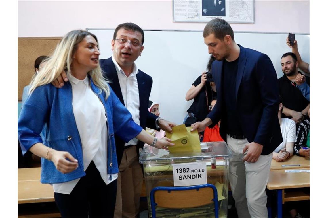 Ekrem Imamoglu (M) mit seiner Frau Dilek (l) und seinem Sohn bei der Stimmabgabe. Foto: Lefteris Pitarakis/AP