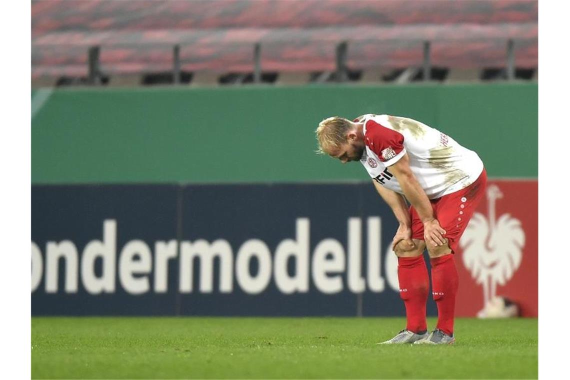 Essens Felix Herzenbruch steht nach der Niederlage gegen Holstein Kiel enttäuscht auf dem Rasen. Foto: Martin Meissner/AP POOL/dpa