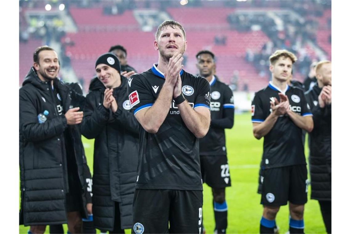 Fabian Klos (M) und Kollegen lassen sich nach dem ersten Saisonsieg von ihren Fans feiern. Foto: Tom Weller/dpa