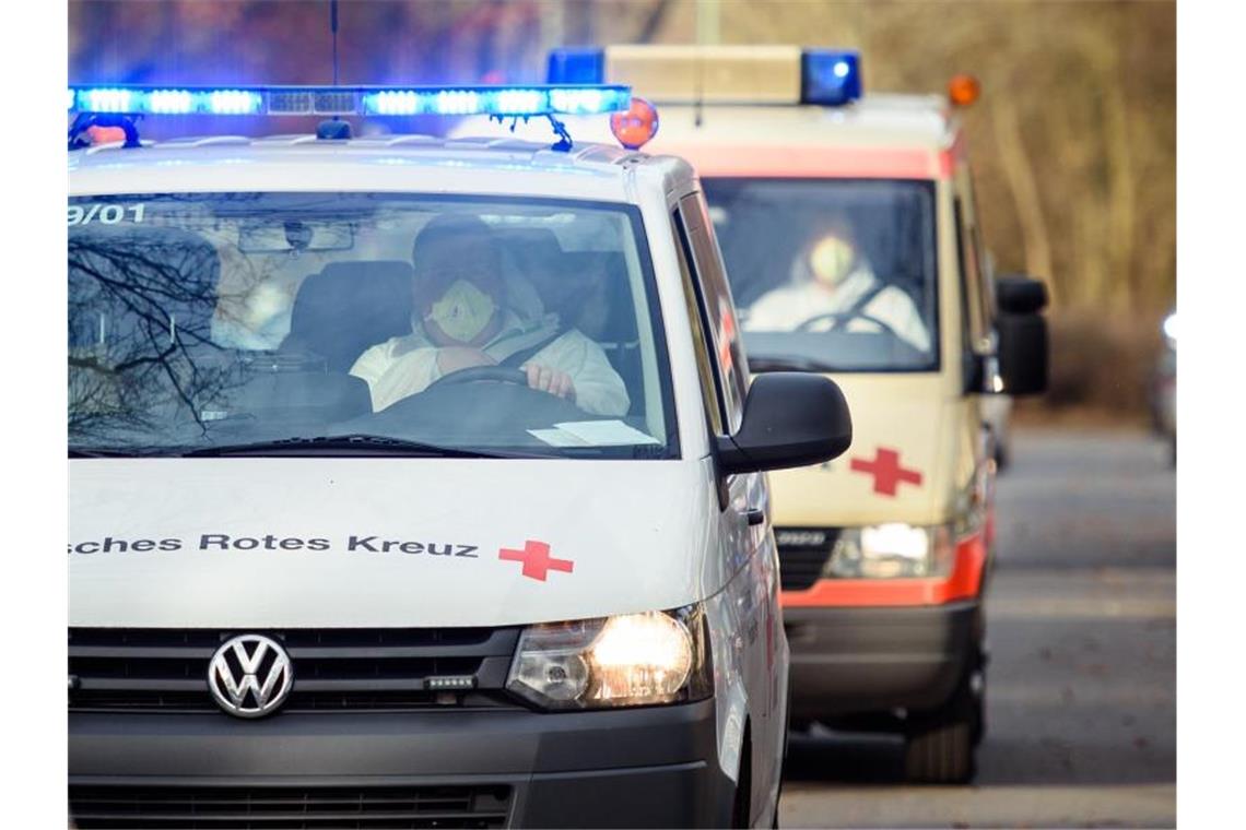 Fahrzeuge des Deutschen Roten Kreuzes fahren unter Polizeischutz auf das Gelände der DRK Kliniken Berlin-Köpenick. Foto: Gregor Fischer/dpa