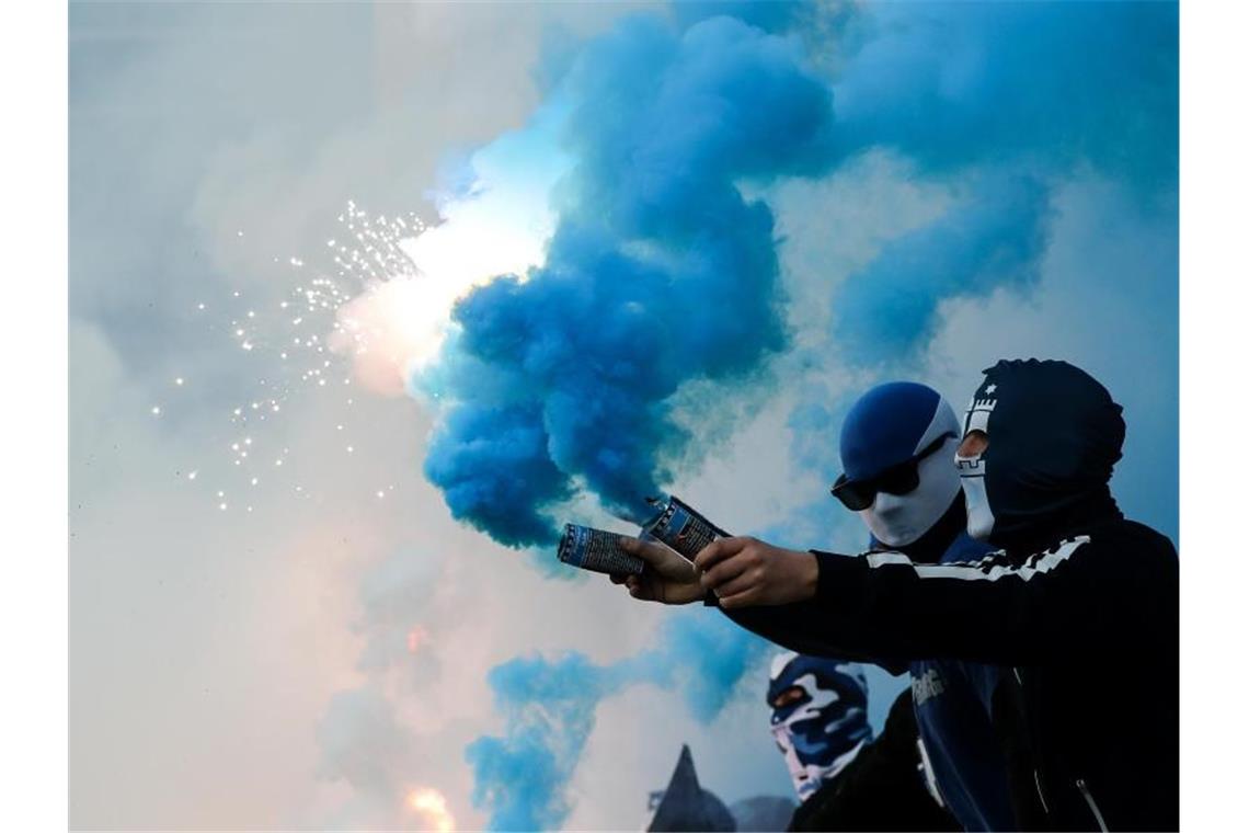 Fans des Hamburger SV brennen Pyrotechnik ab. Foto: Christian Charisius/dpa