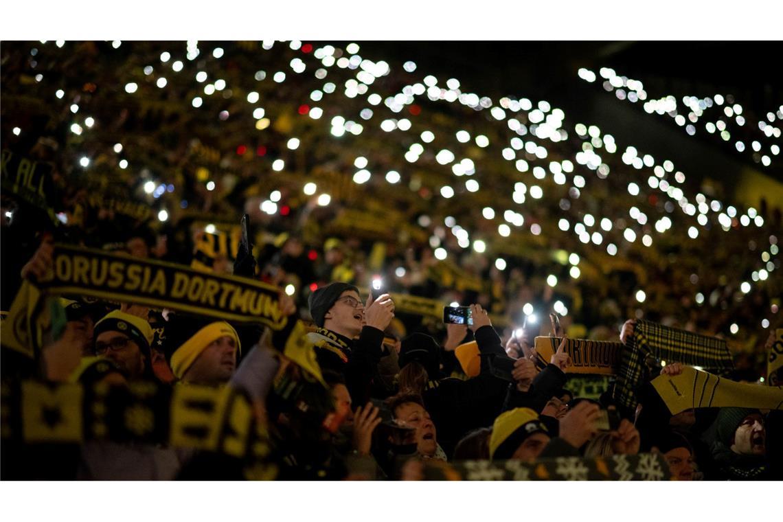 Fans stehen beim traditionellen Weihnachtssingen auf der Süd-Tribüne im BVB-Stadion.