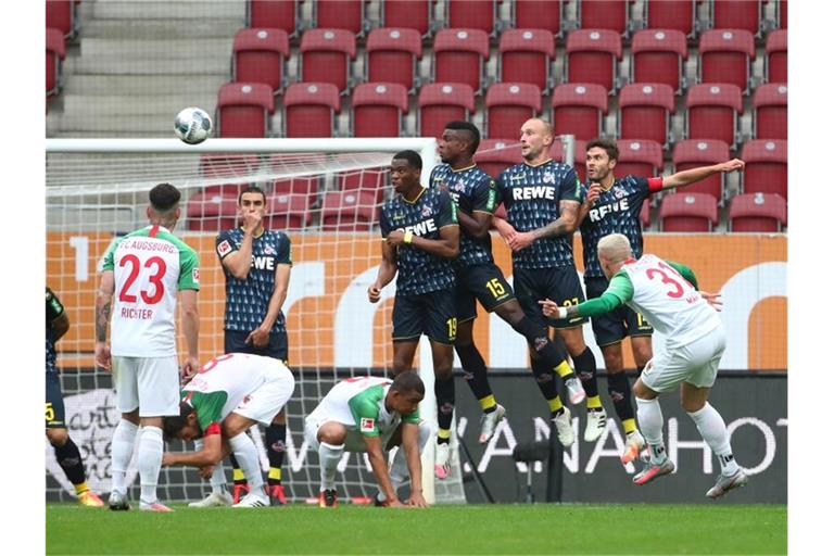 FC Augsburgs Philipp Max schießt den Freistoß über die Mauer aufs Tor. Foto: Michael Dalder/Reuters-Pool/dpa