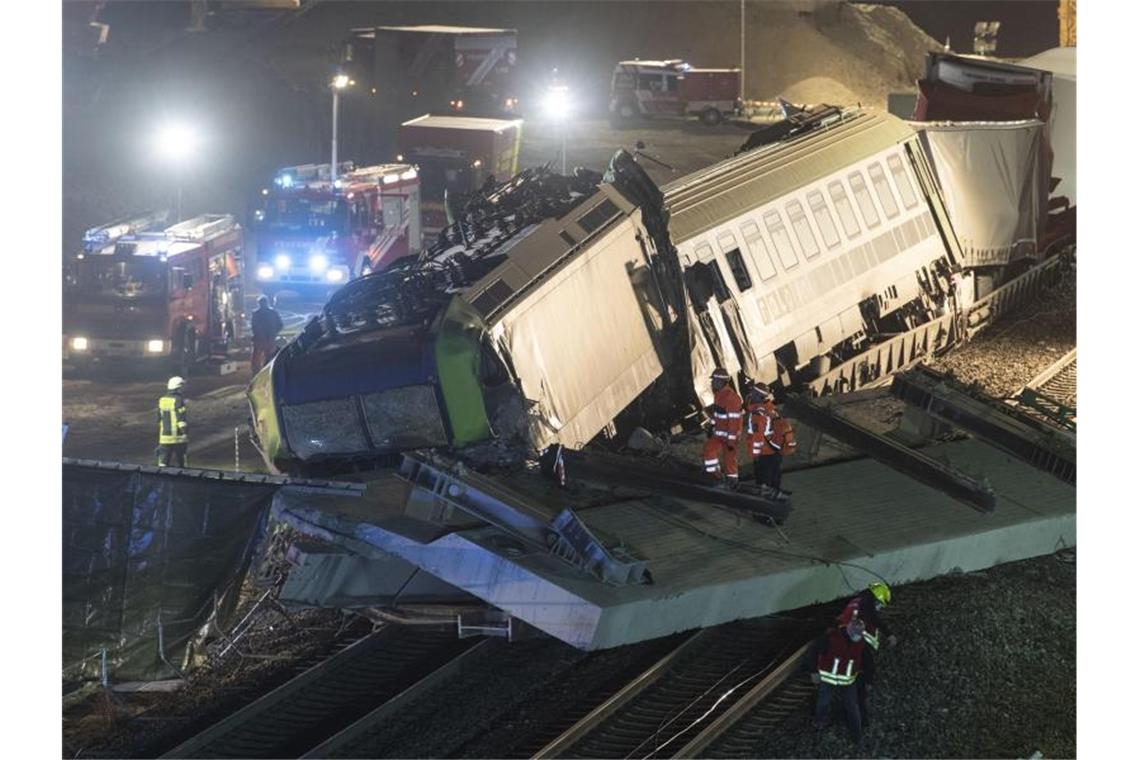 Feuerwehrfahrzeuge stehen um einen verunglückten Zug. Foto: Patrick Seeger/dpa