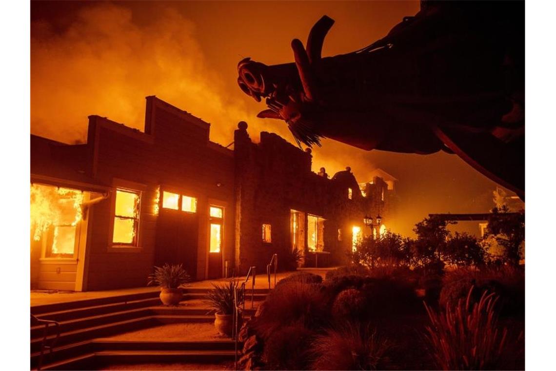 Flammen steigen aus dem Soda Rock Weingut auf. Die seit Tagen wütenden Waldbrände haben Dutzende Häuser zerstört. Foto: Noah Berger/AP/dpa