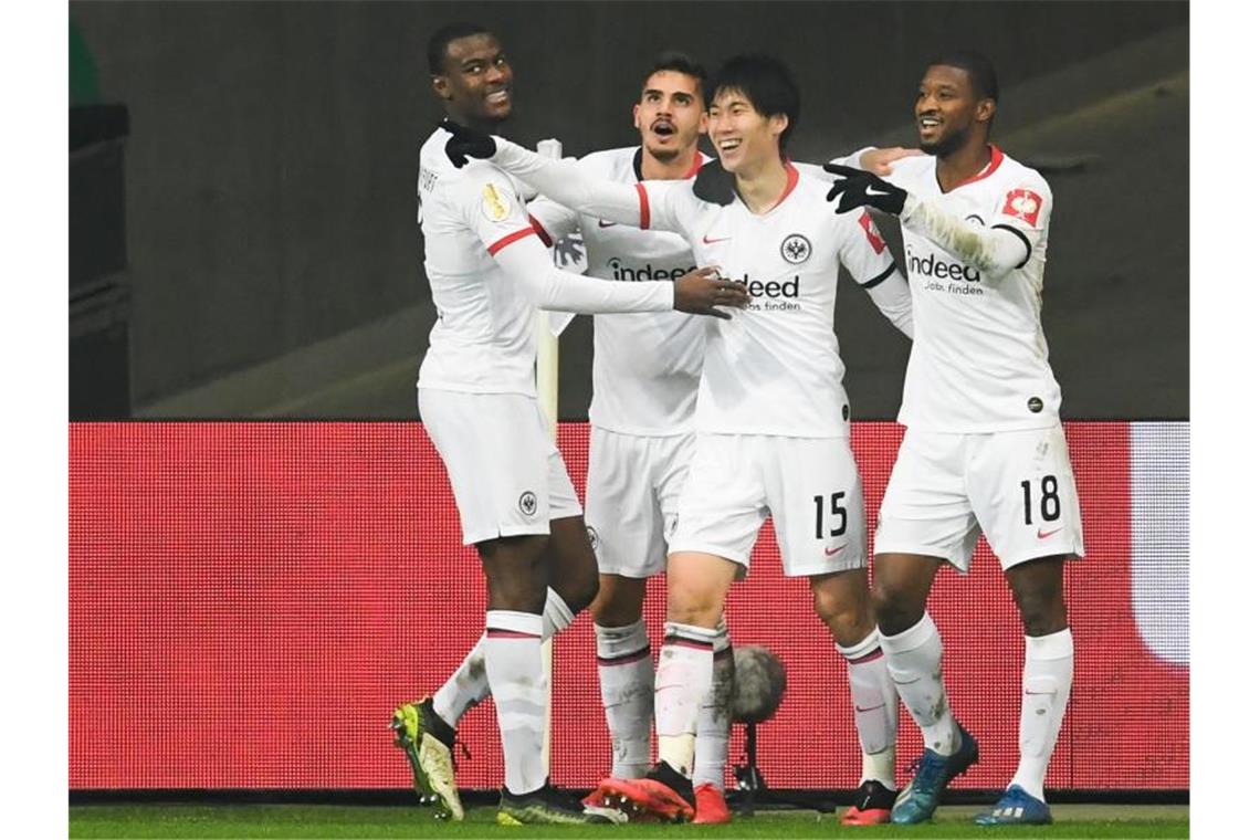 Eintracht Frankfurt träumt von Berlin Frankfurts Torschütze Daichi Kamada (2.v.r) jubelt mit Teamkameraden nach dem zweiten Tor. Foto: Arne Dedert/dpa