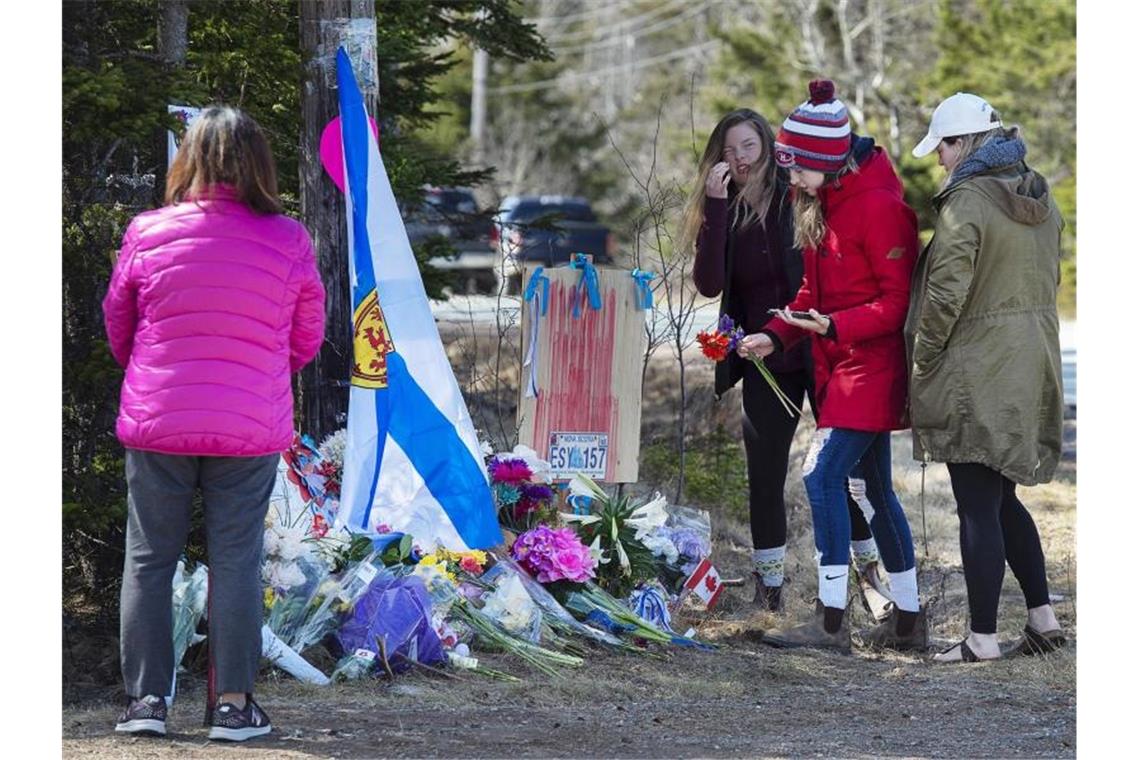 Frauen legen Blumen an einer Gedenkstätte für die Opfer des Amoklaufs in Nova Scotia ab. Als Reaktion auf die schlimme Bluttat hat Kanada die Waffengesetze verschärft. Foto: Andrew Vaughan/The Canadian Press/dpa