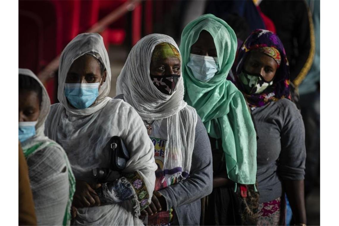 Äthiopien wählt: Lange Schlangen in Addis Abeba Frauen warten in einem Wahllokal darauf, bei der Parlamentswahl ihre Stimmen abzugeben ab. Premierminister und Nobelpreisträger Ahmed hofft darauf, im Amt bestätigt zu werden. Foto: Ben Curtis/AP/dpa