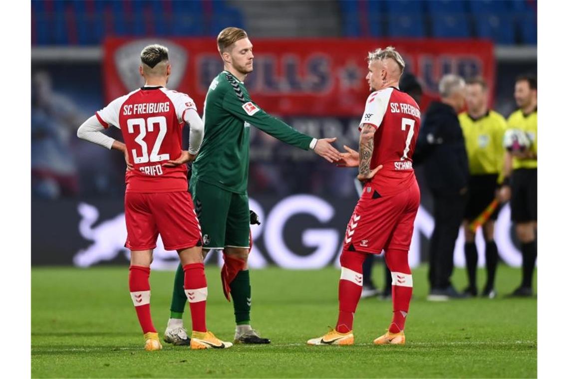 Reaktionen nach dem 3:0 von RB Leipzig gegen den SC Freiburg Freiburgs Vincenzo Grifo (v.l.), Florian Müller und Jonathan Schmid reagieren nach dem Spiel. Foto: Hendrik Schmidt/dpa-Zentralbild/dpa