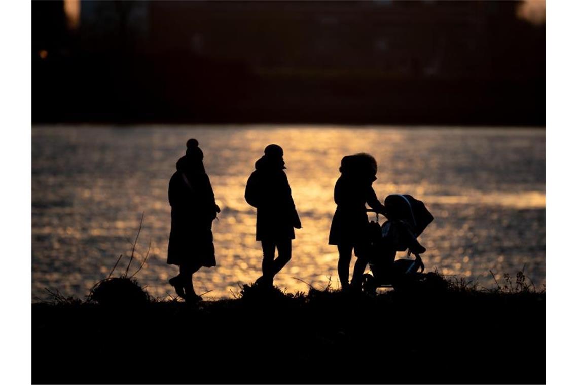 Frische Luft schnappen: Eine Familie ist bei sonnigem Wetter in Hamburg unterwegs. Foto: Daniel Reinhardt/dpa