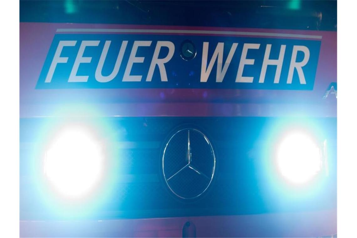 Hoher Schaden bei Dachstuhlbrand: Zwei Verletzte Frontblitzer strahlen an der Front eines Feuerwehrfahrzeuges und der Aufschrift „Feuerwehr“. Foto: Patrick Seeger/dpa/Symbolbild