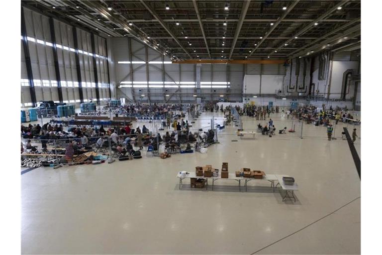 Für die Abfertigung von Passagieren, die zu ihrem nächsten Ziel transportiert werden sollen, wurde ein Wartungshangar in einen kleinen internationalen Flughafen umgewandelt. Foto: Senior Airman Taylor Slater/U.S. Air Force via AP/dpa