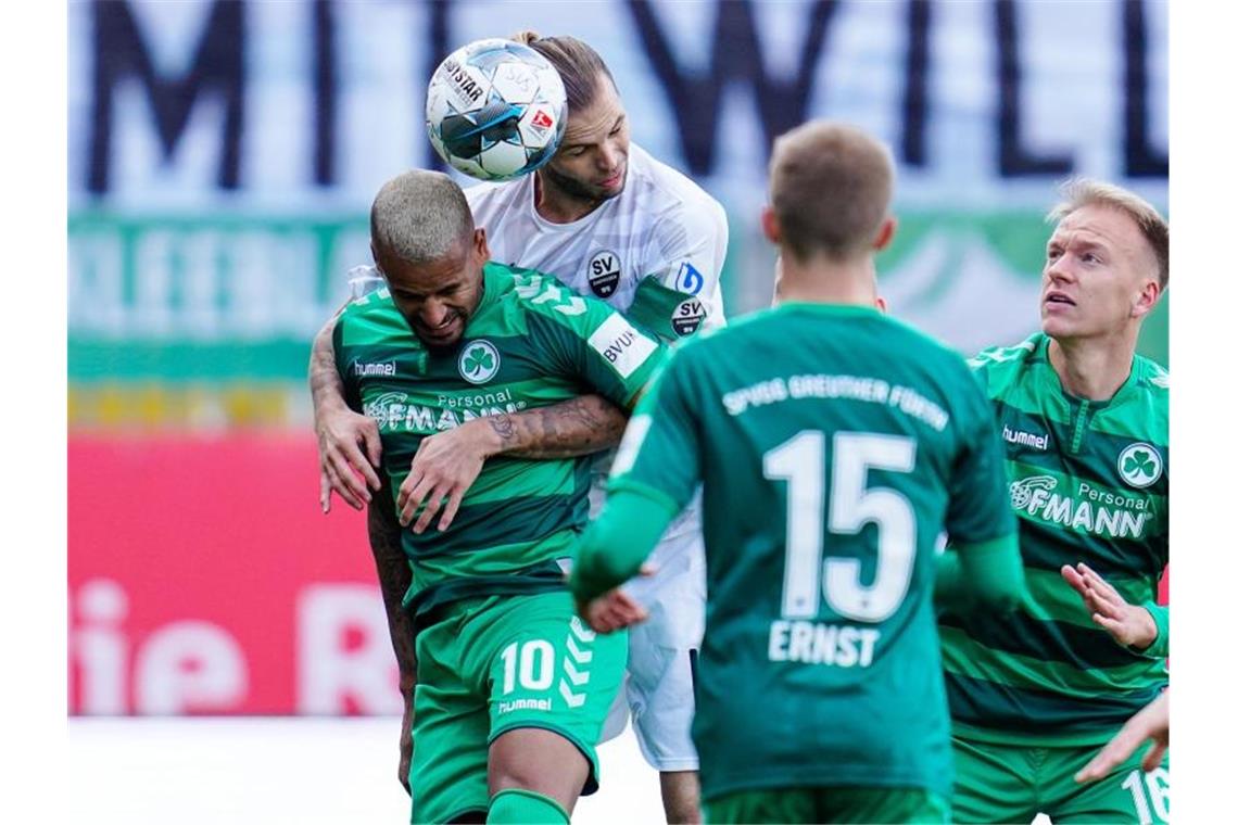 Fürths Daniel Keita-Ruel (vorne) und Sandhausens Dennis Diekmeier kämpfen um den Ball. Foto: Uwe Anspach/dpa