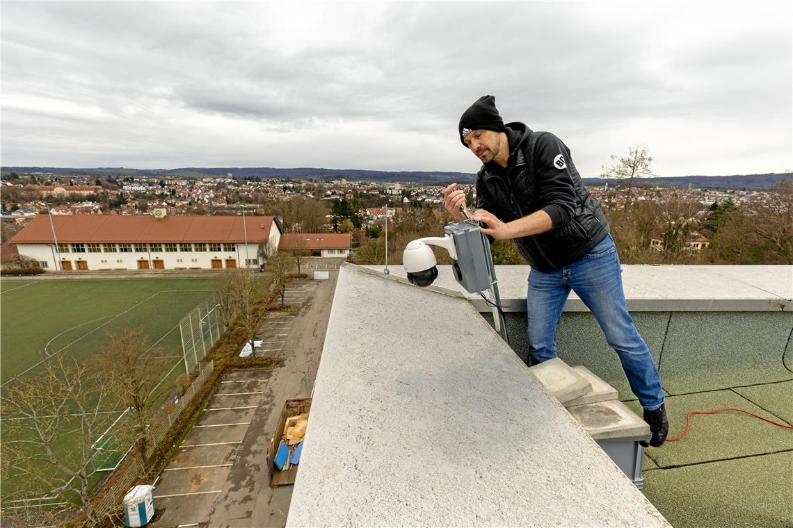 Georg Beïs installiert die Kamera auf dem Dach des Max-Born-Gymnasiums. Sie macht pro Minute ein Bild und überträgt diese an einen Server. Foto: Alexander Becher