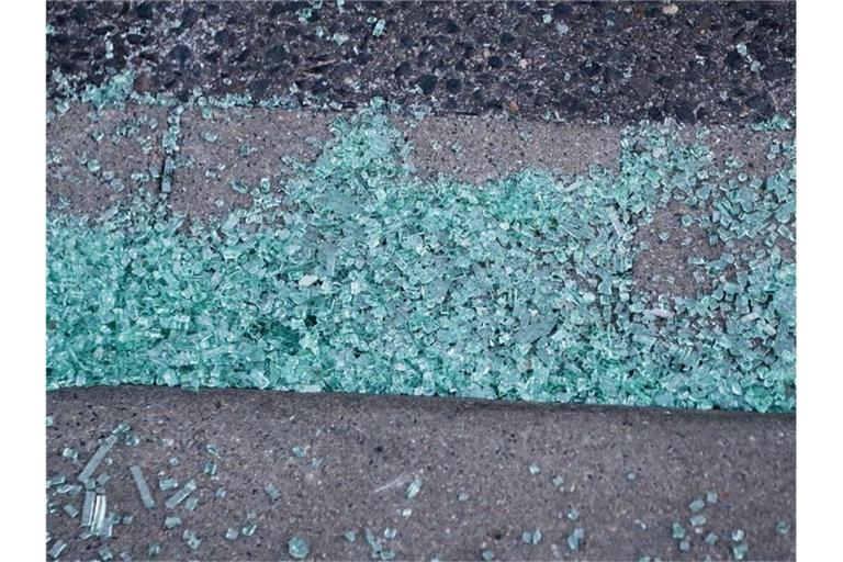 Glasscherben einer Autoscheibe liegen auf einem Gehweg in Stolberg. Die Generalstaatsanwaltschaft sieht einen möglichen Zusammenhang der Tat mit der Kommunalwahl in Nordrhein-Westfalen. Foto: David Young/dpa